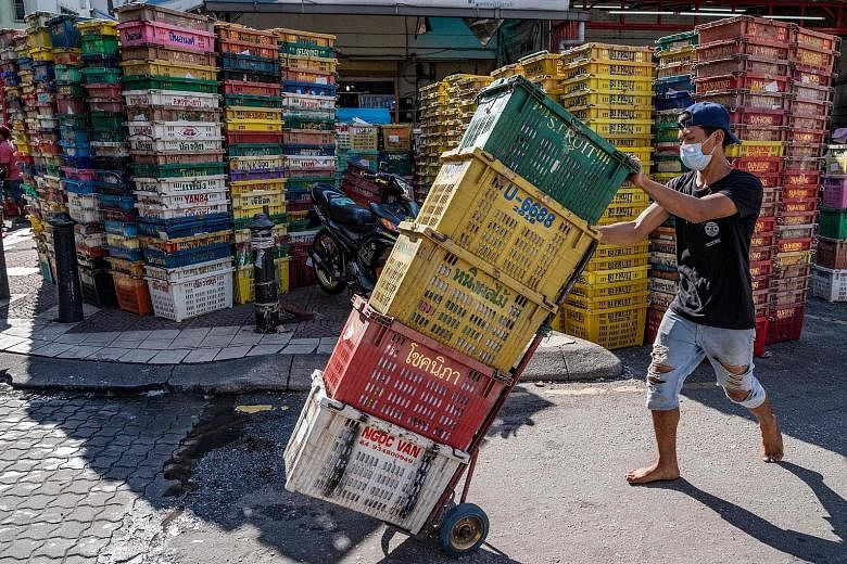 A fruit market in Kuala Lumpur on Monday, when the Malaysian government began relaxing the movement control order, including allowing some retail shops in malls to reopen as long as they follow mandatory coronavirus safety rules. Wholesale and retail