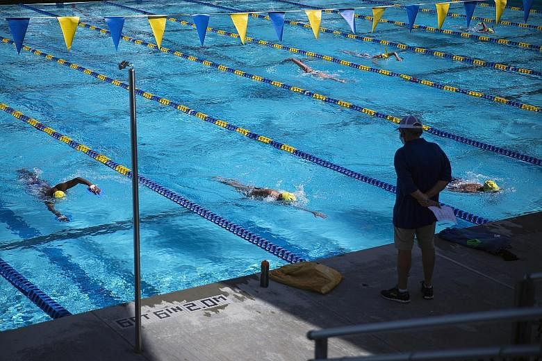 Coach Mark Schubert overseeing Mission Viejo Nadadores swim practice on Wednesday in California. The rules may differ but the athletic world is creeping back towards competition. 
