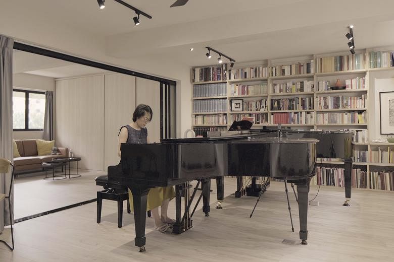 The four-room HBD flat of music teachers Pamela Krakauer (above) and Peter Krakauer houses two pianos – an August Forster and a Steinway M – and plenty of shelving.