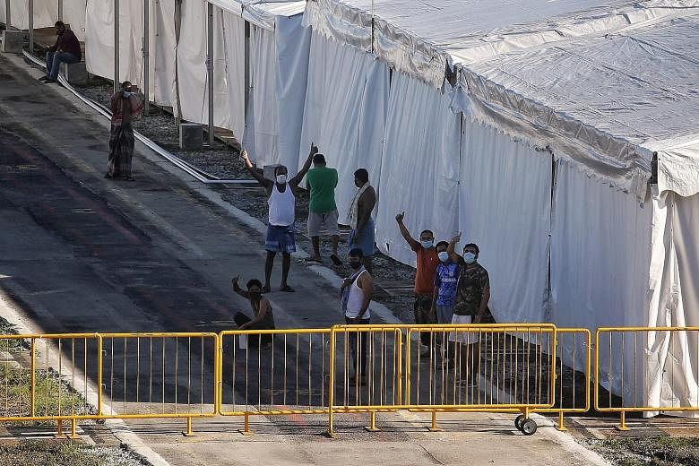 Migrant workers seen at the Tanjong Pagar Terminal facility. The site includes tentage with beds and floating accommodation to house patients who are currently recovering or who have recovered from Covid-19. ST PHOTO: KEVIN LIM