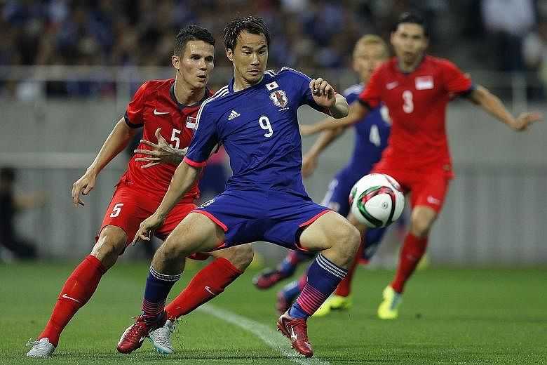 Japan's Shinji Okazaki on the ball as Singapore's Baihakki Khaizan marks him during the 2018 World Cup Asian qualifiers second-round match at the Saitama Stadium in June 2015. The game ended 0-0 as the Lions pulled off a stunner. PHOTO: EPA-EFE