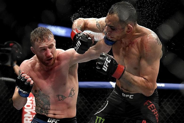 Justin Gaethje (left) hurting Tony Ferguson en route to a technical knockout victory in the fifth round of their UFC 249 lightweight bout on Saturday. 