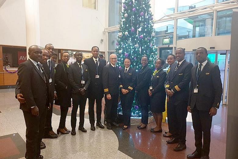 Ms Seng, pictured here with some of her colleagues at RwandAir. She decided to stay put in Rwanda even though many of her foreign colleagues returned to their home countries just before Rwanda's lockdown measures kicked in on March 22.