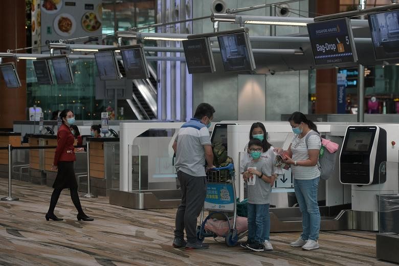 Travellers at Changi Airport in February. Passengers on SIA and SilkAir flights are required to observe safe distancing measures. ST PHOTO: KUA CHEE SIONG