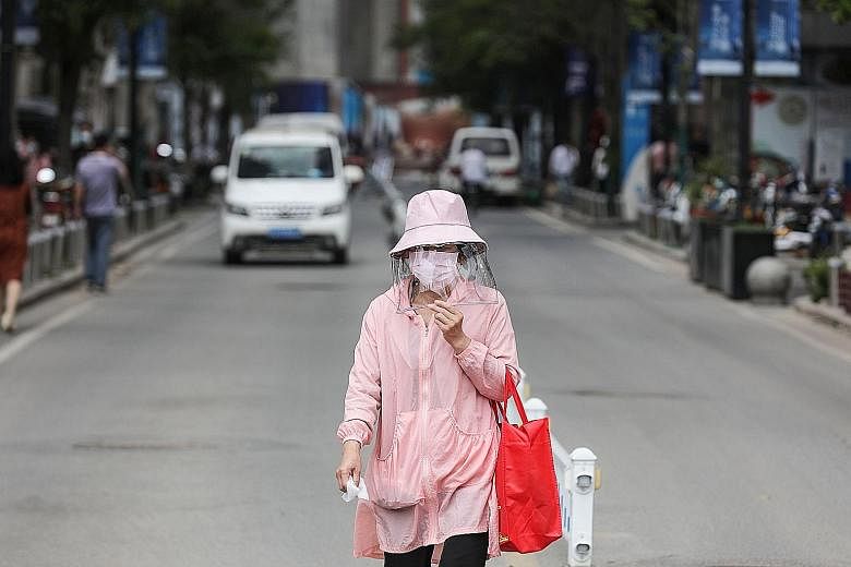 A woman in Wuhan with her own personal protection gear yesterday. The city, which was the epicentre of China's coronavirus outbreak, had emerged from a lockdown only about a month ago. It reported six new cases over the weekend, pushing China's overa