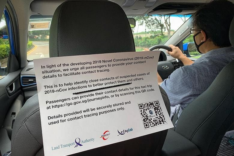 A notice in a ComfortDelGro taxi yesterday asking passengers to provide their contact details for the trip. All cabs will eventually have the QR codes, which are being rolled out across the industry from today. ST PHOTO: ARIFFIN JAMAR