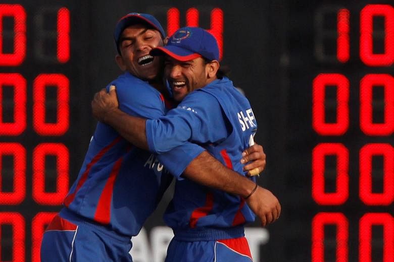 Shafiqullah Shafaq (far right) and Samiullah Shinwari celebrating a Bangladesh wicket in the 2010 Asian Games final, as Afghanistan took the silver after losing by five wickets. PHOTO: REUTERS