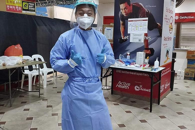 Khoo Zhihao needs to be in full protective gear if he comes into contact with infected patients during his shift at the Clementi Sports Hall, which houses foreign workers who provide essential services and do not have Covid-19 symptoms. PHOTO: COURTE