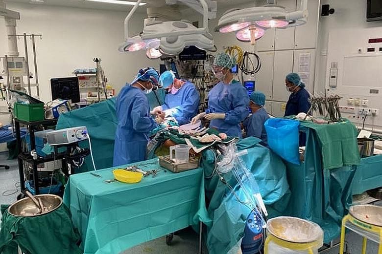 Doctors performing heart bypass surgery at a hospital here last week. Since the circuit breaker period started on April 7, only essential healthcare services have been allowed to continue.