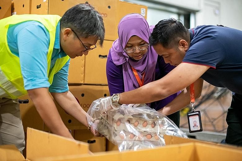 Above: Trade and Industry Minister Chan Chun Sing says Singapore has taken steps to shore up its resilience, such as by diversifying its sources of supply. Right: In March, a Singapore Airlines cargo plane brought in 300,000 eggs from Thailand, as th