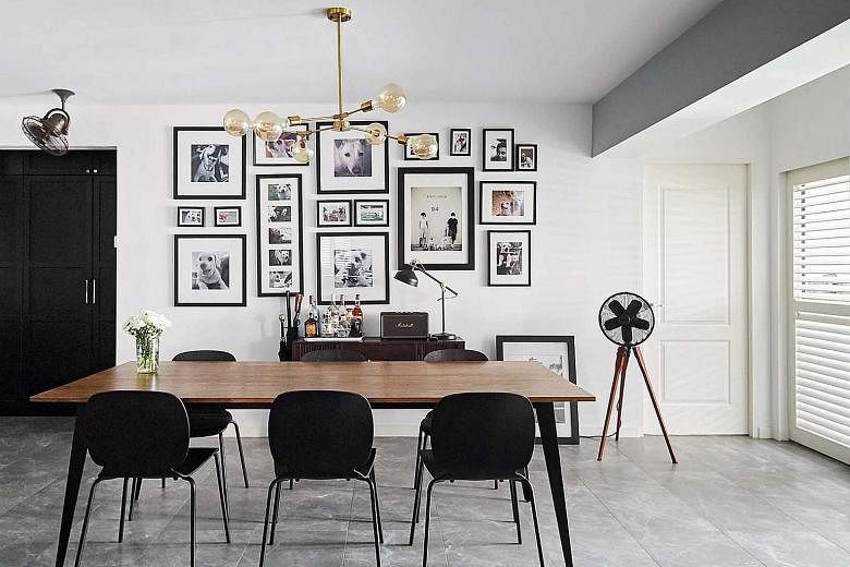 A wall of photographs near the dining table is an ode to the dogs of the home owners. 
