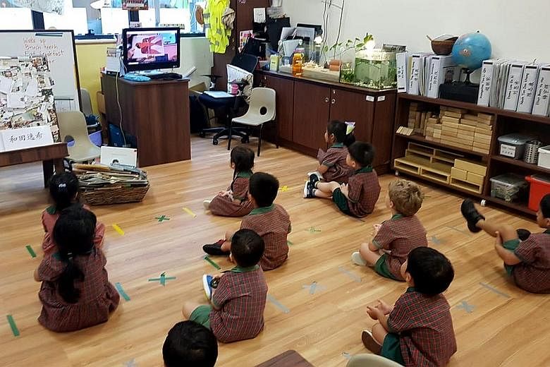 Children preparing for home-based learning, while sitting 1m apart, at an EtonHouse Pre-School in Mountbatten Road before the circuit breaker.