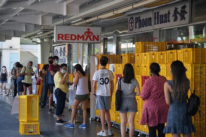 Long queues at the Phoon Huat store (above) in Toa Payoh last Thursday. With more customers stocking up on baking supplies, the shop has run out of some ingredients.