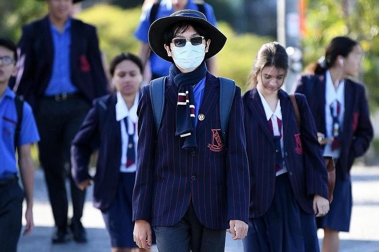AUSTRALIA: A student wearing a surgical mask in Brisbane, Queensland, last week. Students across Queensland were returning to classrooms for the first time in weeks after a period of learning from home.