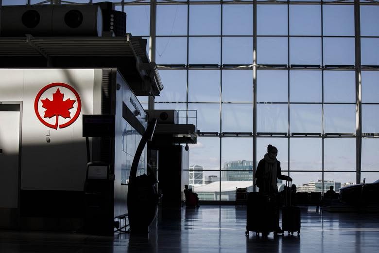 An Air Canada logo at Toronto Pearson International Airport in Canada. The airline has announced that it will lay off at least half of its staff due to the collapse of its business during the coronavirus pandemic.