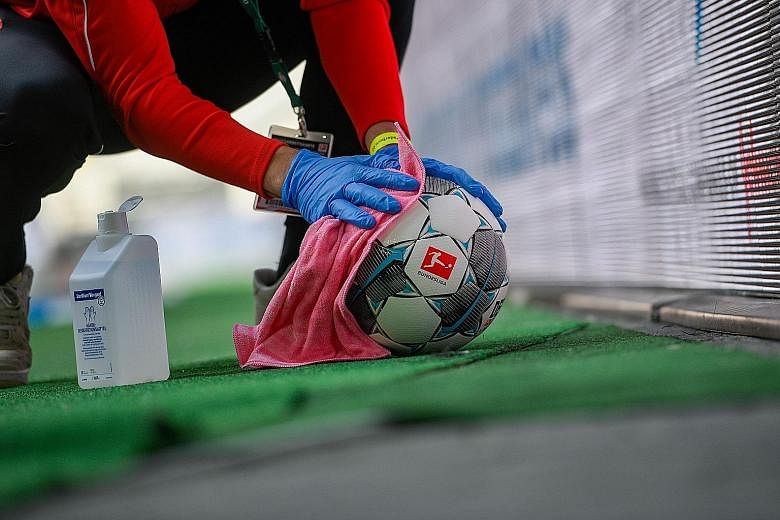 What they did right – A football being disinfected during the draw between Dusseldorf and Paderborn.