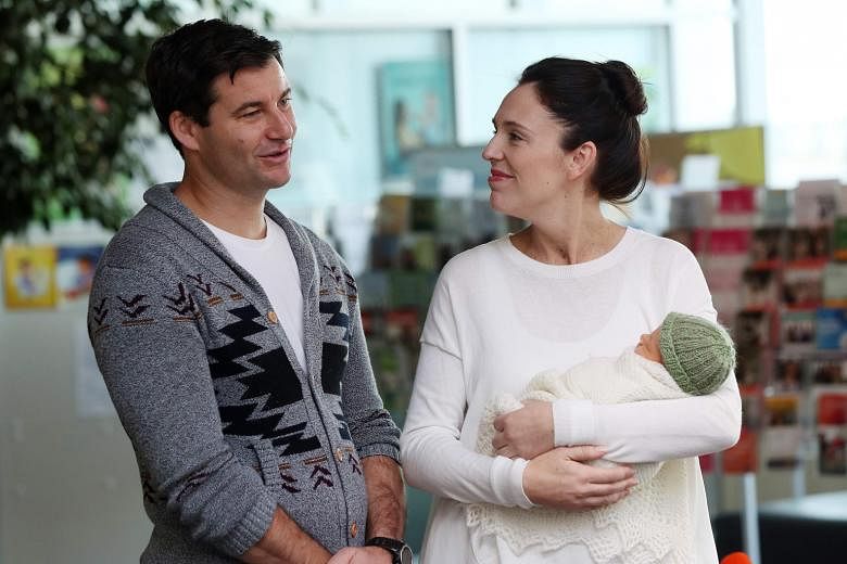 A 2018 file photo of New Zealand Prime Minister Jacinda Ardern and her partner Clarke Gayford with their infant daughter, Neve Te Aroha Ardern Gayford, outside a hospital in Auckland.