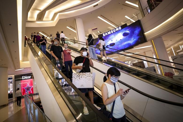 Shoppers at a shopping mall in Bangkok yesterday - the first day Thailand allowed its malls and department stores to open since March as the number of new coronavirus cases falls.