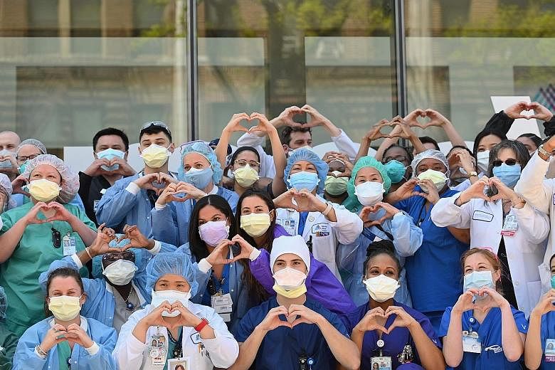 Nurses and healthcare workers gesturing love in celebration of Nurse Week and International Nurses Day outside Mt Sinai Queens in the Queens borough of New York City last Tuesday. ProPublica reported that at least 30 Filipino health workers had died 