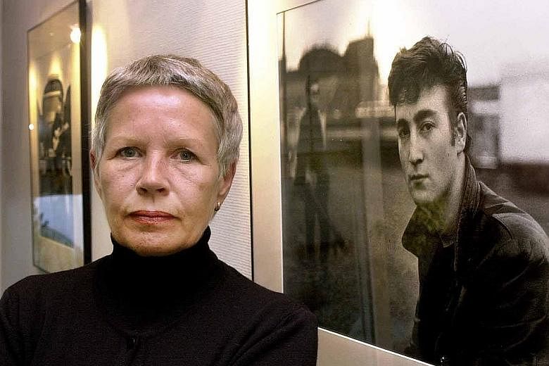 German photographer Astrid Kirchherr (in a 2000 file photo, in Itzehoe, Germany) in front of one of her photos featuring former Beatle John Lennon.