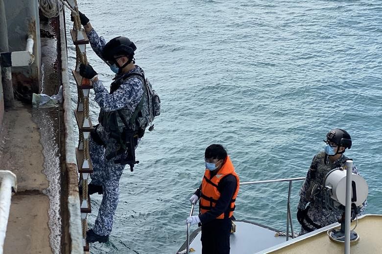 An Accompanying Sea Security Team operator climbing a Jacob's ladder during a recent boarding operation. Such operations involve checking ships for stowaways and suspicious goods and activities.