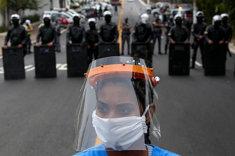 A Paraisopolis resident protesting in Sao Paulo, Brazil, on Monday to demand more state government aid amid the Covid-19 crisis. PHOTO: AGENCE FRANCE-PRESSE