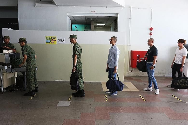 Recruits on their day of enlistment at the SAF Ferry Terminal on April 1. The resumption of basic military training is necessary to generate operational units as well as select commanders for training at the Officer Cadet and Specialist Cadet schools