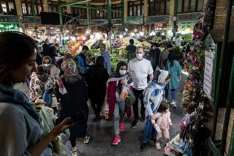 Shoppers at a bazaar in Teheran last Thursday, after restrictions were lifted late last month. Iran, the epicentre of the coronavirus outbreak in the Middle East, reopened without meeting the benchmarks recommended by health experts and has been hit 