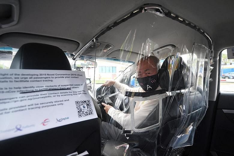 Taxi driver Koh Tian Moo, 66, in a cab that has been fitted with a plastic shield to minimise contact between drivers and passengers amid the Covid-19 outbreak. ComfortDelGro Corp will fit 400 of its 10,000 cabs with these shields as part of a trial.