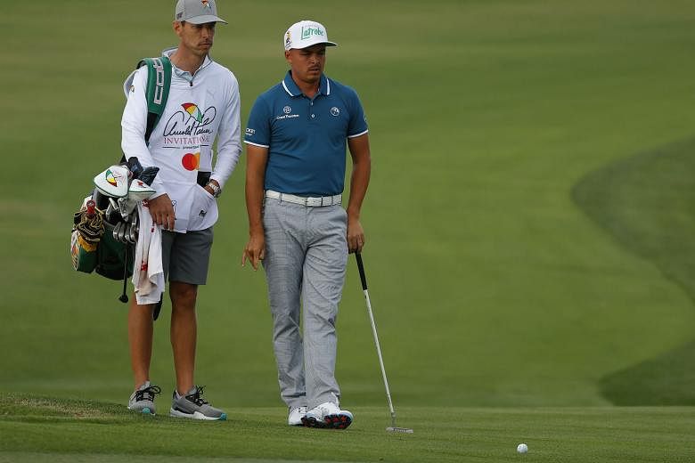 Rickie Fowler, ably accompanied by his caddy Joe Skovron, at the 11th hole of the Arnold Palmer Invitational in March.
