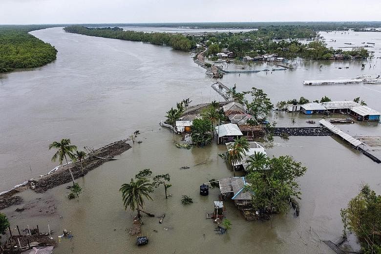 Houses submerged in floodwaters in Shyamnagar, in the Indian state of West Bengal, after Cyclone Amphan caused a dam to break. Chief Minister Mamata Banerjee said at least 72 people had died. In neighbouring Bangladesh, the initial toll was put at 10