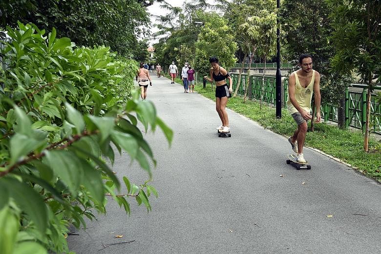 Left: Even after the circuit breaker period ends on June 1, people who need to exercise should do so in their immediate neighbourhood, such as at a park or park connector near them. Below: Apart from face masks, plastic face shields can be worn by st