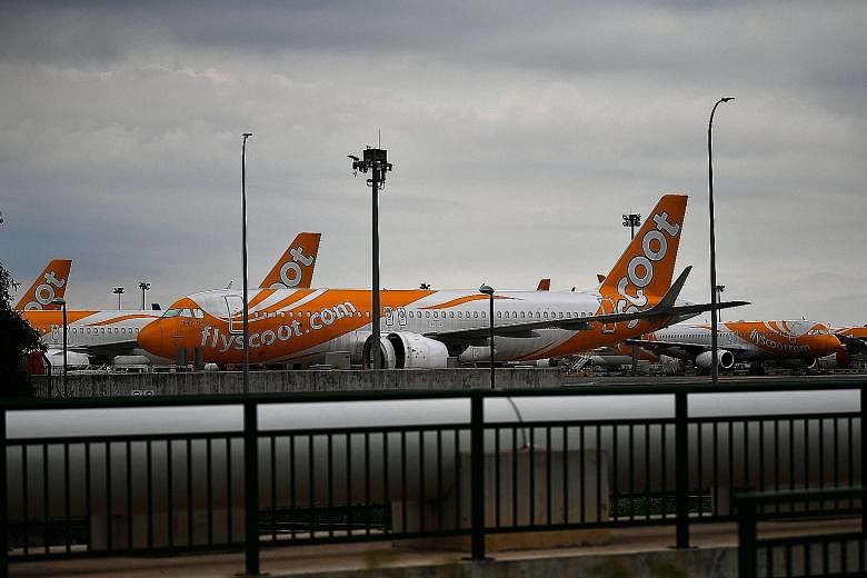 Planes on the tarmac at Changi Airport yesterday. Some taxiways at the airport have been converted into parking spaces, and 143 planes from Singapore Airlines, SilkAir, Scoot and Jetstar Asia are grounded there.