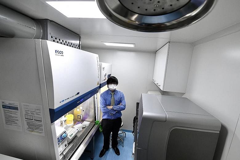 Esco Aster chief executive Lin Xiangliang inside a mobile testing lab that will allow diagnostic tests to be conducted in a smaller offsite location, for example, in a container that is 3m long, instead of in a laboratory.