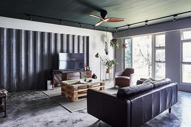 The home owners opted for a green study wall because they love plants and greenery. Corrugated galvanised iron sheets create striking backdrops in the kitchen and living room (above), while an armchair made from aeroplane fuselage complements the industri