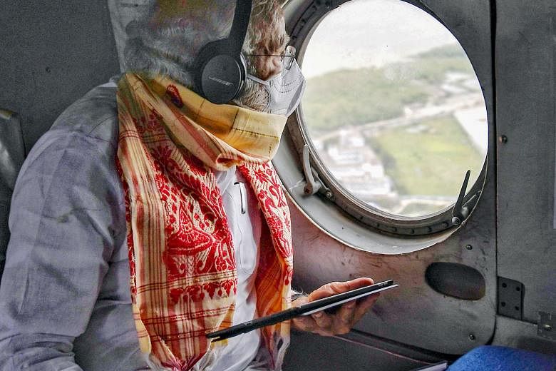 India's Prime Minister Narendra Modi (above) getting an aerial view yesterday of storm-hit areas in West Bengal (right). Cyclone Amphan killed at least 96 people in India and Bangladesh after it swept in from the Bay of Bengal on Wednesday. Most of t