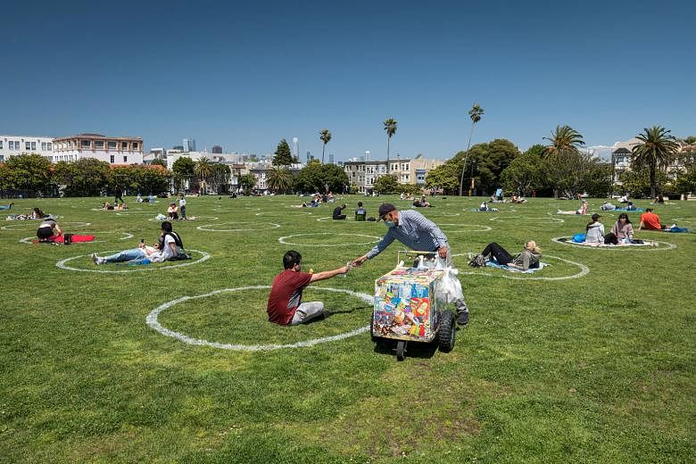 People relaxing within circles marked out on the grass to promote social distancing to curb the spread of the coronavirus in San Francisco, California, on Thursday.