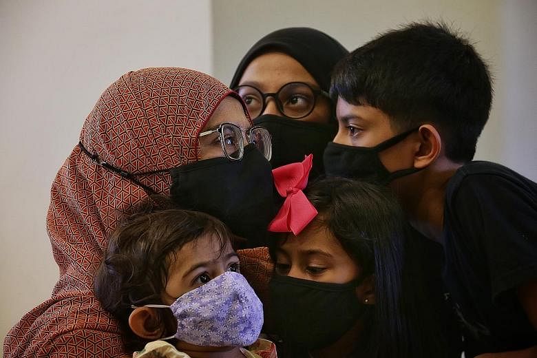 Madam Seha (not her real name) with her children (clockwise from top) - her 13-year-old daughter, 11-year-old son, six-year-old daughter and two-year-old daughter. She, her husband and children tested positive for the coronavirus and were all hospita