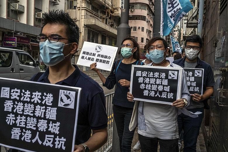 Activists marching in Hong Kong on Friday in protest against Beijing's proposed national security law for the city. Under the Basic Law, Hong Kong's mini-Constitution, the city is obliged to pass a national security law, but lawmakers have desisted s