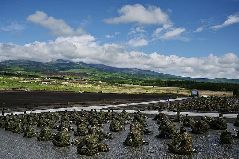Soldiers from the Japan Ground Self-Defence Force taking part in a live-firing exercise at the Higashi-Fuji firing range in Gotemba, Shizuoka prefecture, yesterday. Despite the coronavirus outbreak, Japan's defence forces have continued to conduct mi