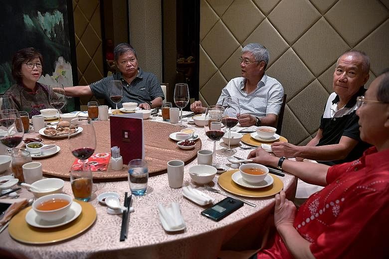 Steven's eldest daughter, Desiree, having dinner with her parents on Feb 7 while her daughters played in the background at Steven's home. Desiree tries to have dinner with her parents as often as she can. (From left) Ms Wong Lai Quen and her husband 