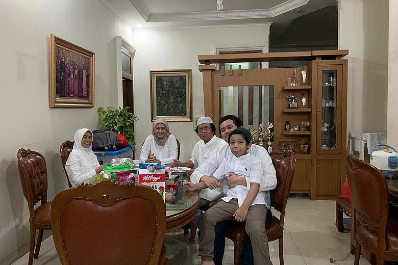 Dr Galoeh Adyasiwi (second from left) with her parents, elder brother and son in Jakarta yesterday. Her husband, who works in South-east Sulawesi, could not fly in to celebrate Hari Raya with her.