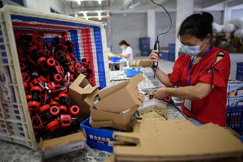 A worker assembling toy cars at a Shantou factory in China's Guangdong province last week. China's economy is stirring back to life after virus cases dwindled from a peak in February, when activity came to a near-halt. But recovery is now hampered by