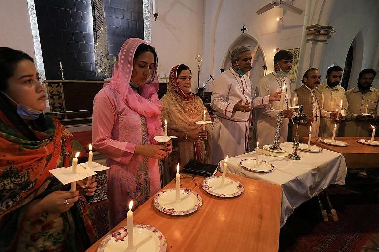 Top: People attending a prayer session at the Cathedral Church of St John, in Peshawar, Pakistan, last Saturday, for victims of the plane crash.