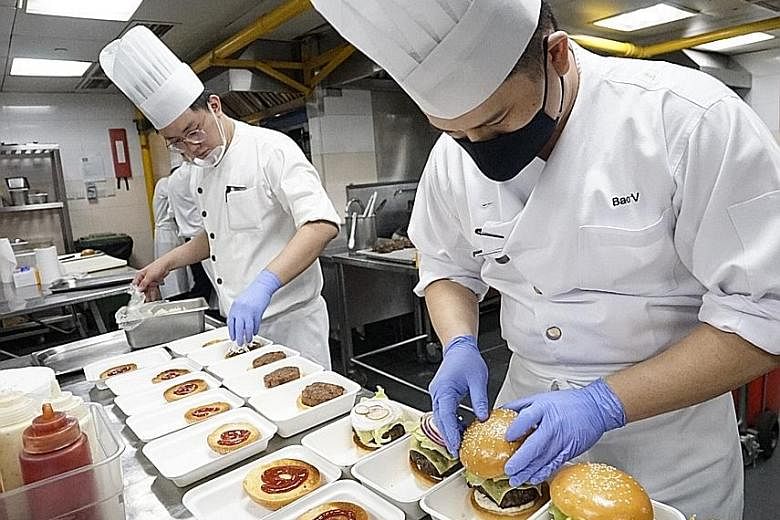 Grand Hyatt Singapore chefs preparing free burgers for F&B employees as part of the Together In Spirits campaign. EuroCham reimburses eateries $20 a meal to cover preparation and delivery costs.