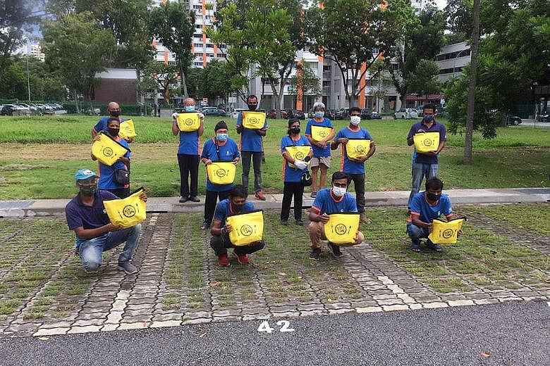 Cleaners from Bishan-Toa Payoh GRC with their Raya Kindness Packs. The packs, containing items like festive cookies and a thermal bag, were also given to cleaners in Tanjong Pagar GRC and Jalan Besar GRC.