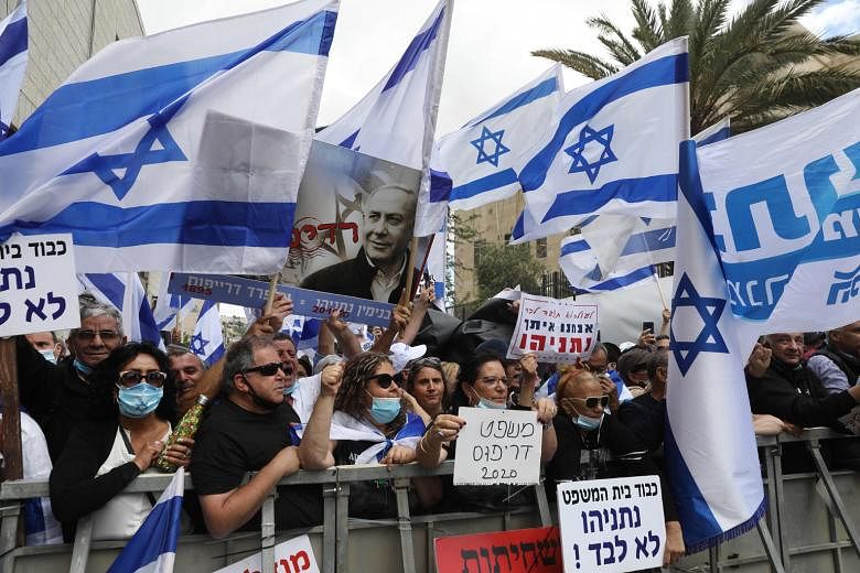 Israelis taking part in a rally in support of Prime Minister Benjamin Netanyahu outside his residence in Jerusalem yesterday.