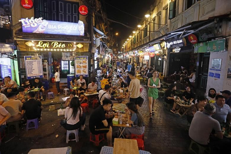 Left: People enjoying a drink at the Bia Hoi Corner in Hanoi's old quarter on Friday. The government this month flagged off a "Vietnamese people travel to Vietnam destinations" campaign.