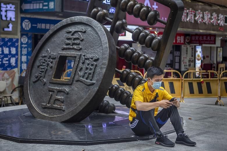 A sculpture depicting the Chinese yuan and abacus in Guangzhou in China's Guangdong province. An official Chinese digital yuan is now in pilot runs to slowly start replacing the physical legal tender. If the experiment succeeds, it will become the wo