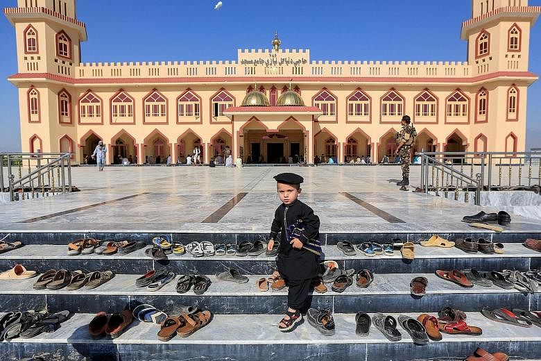An Afghan boy outside a mosque during the Eid al-Fitr holiday in Laghman province, Afghanistan, yesterday. The Taleban made a three-day truce offer that started on Sunday to mark the holiday - a move swiftly welcomed by the Afghan government.